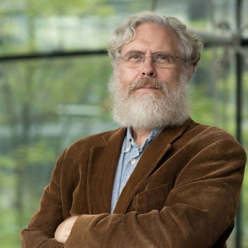 George Church, PhD standing in front of a window 